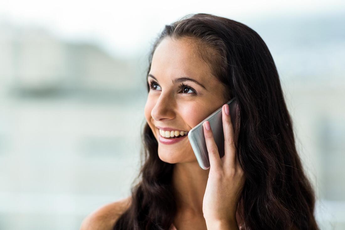 a lady happily taking phone call